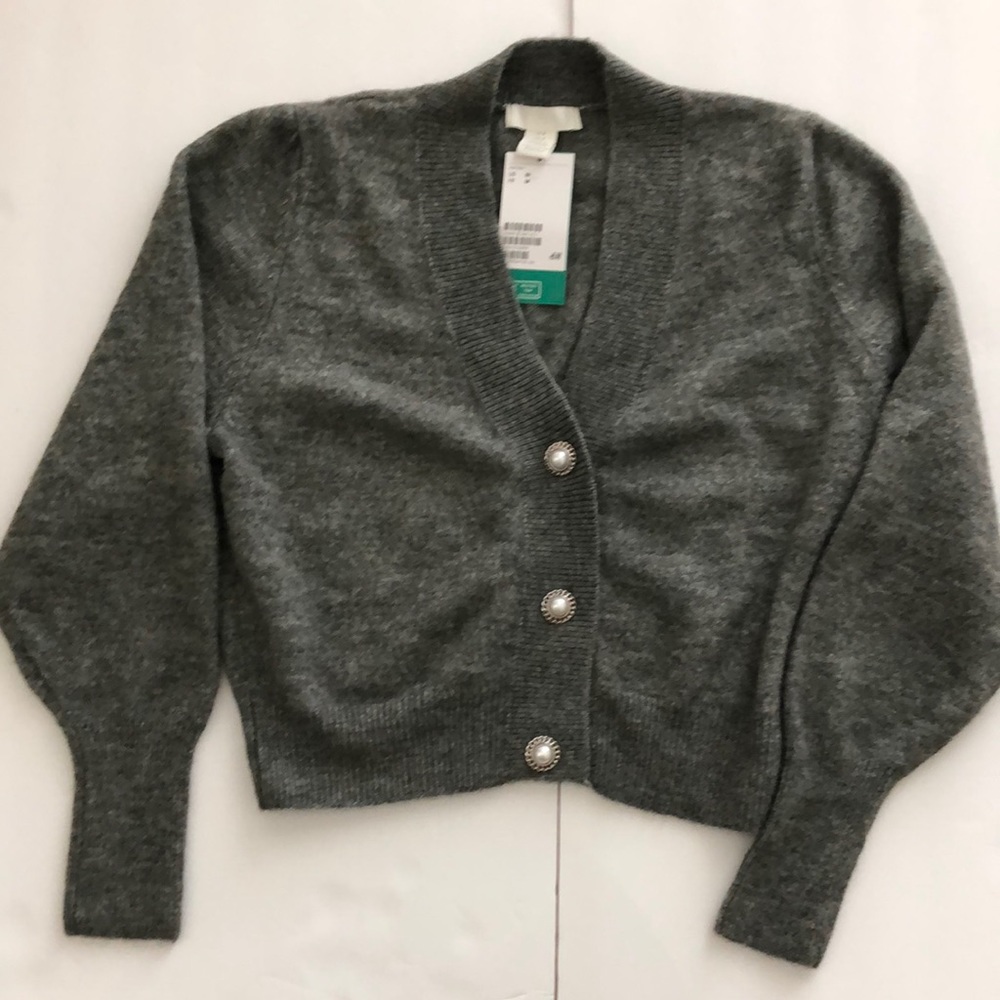 NWT. Grey knit cropped cardigan with rhinestone buttons in size medium.
